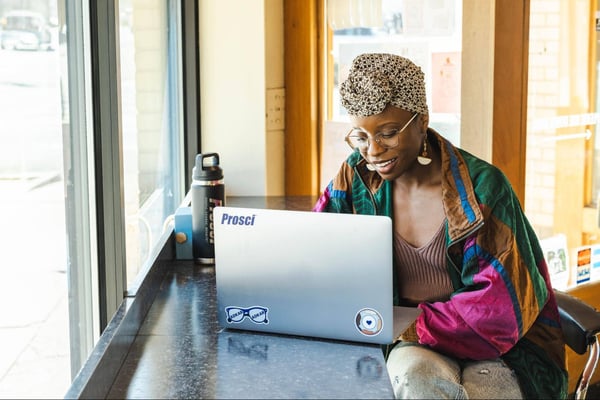 Woman sitting at table using a laptop